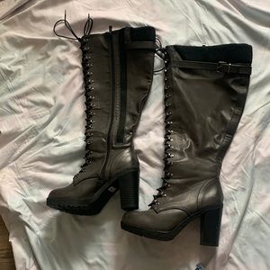 Knee high lace up combat boots.